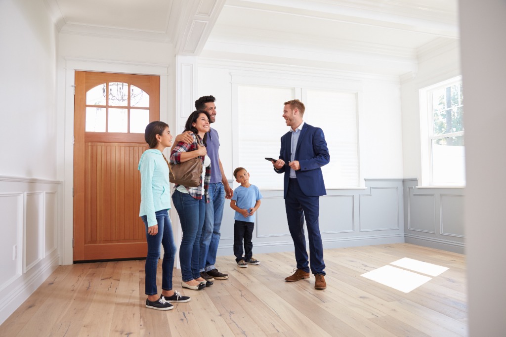 Family talking with a real estate agent