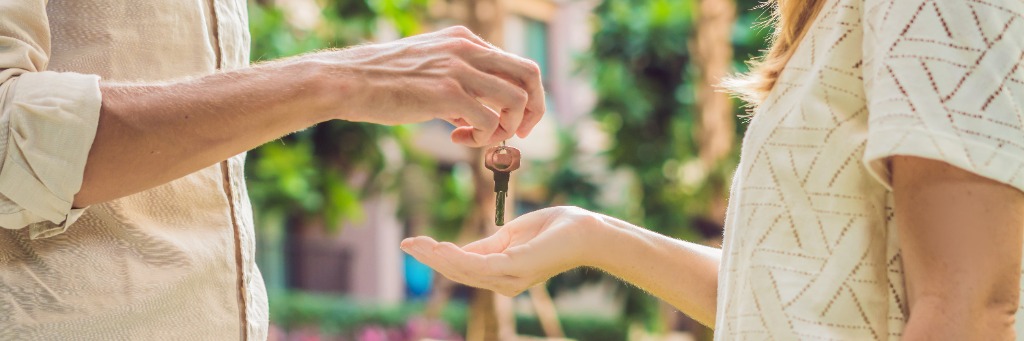 Real estate agent handing over house keys